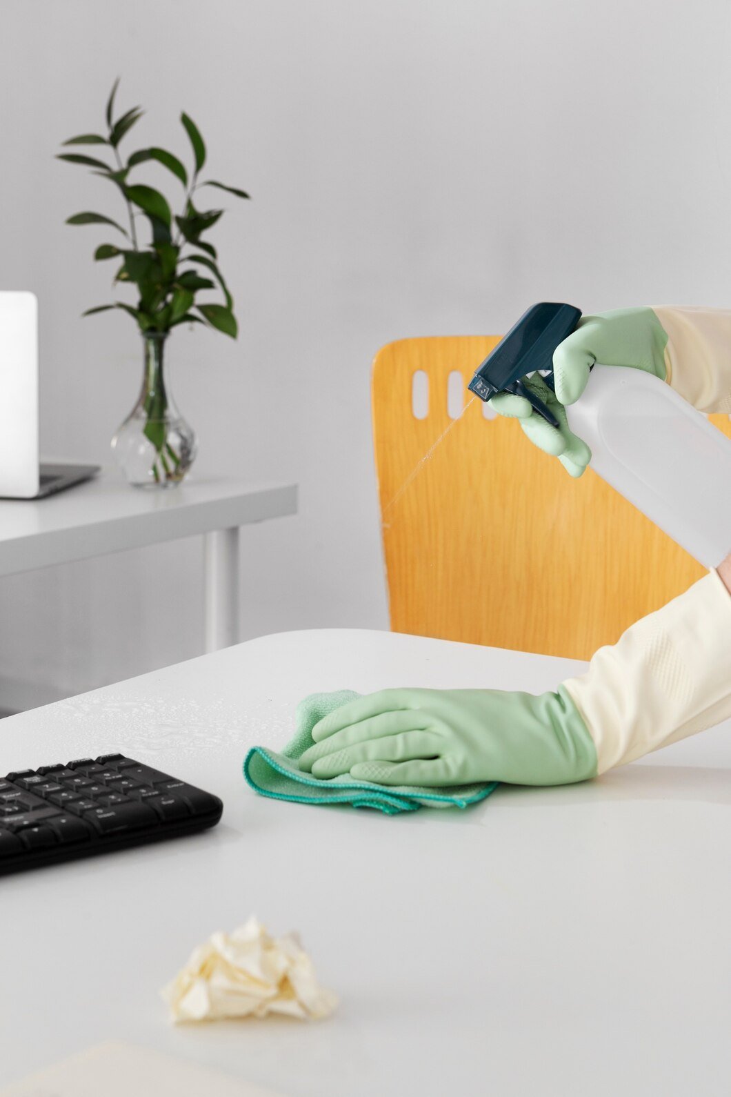 City Wide Cleaning professional disinfecting an office desk