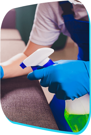 City Wide Cleaning technician disinfecting a surface with gloves and spray